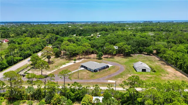 a kitchen with stainless steel appliances a dining table chairs stove refrigerator and cabinets