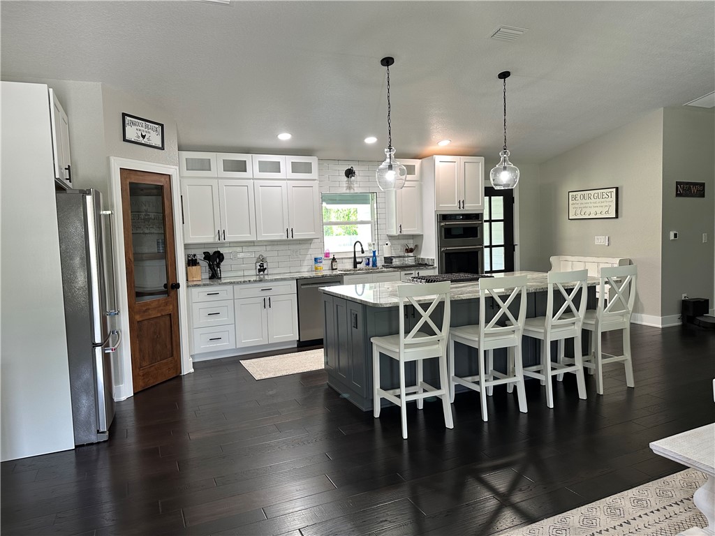 4135 Grant Road Grant Valkaria, FL 32949 - Photo 5 of 26 a large kitchen with a table and chairs