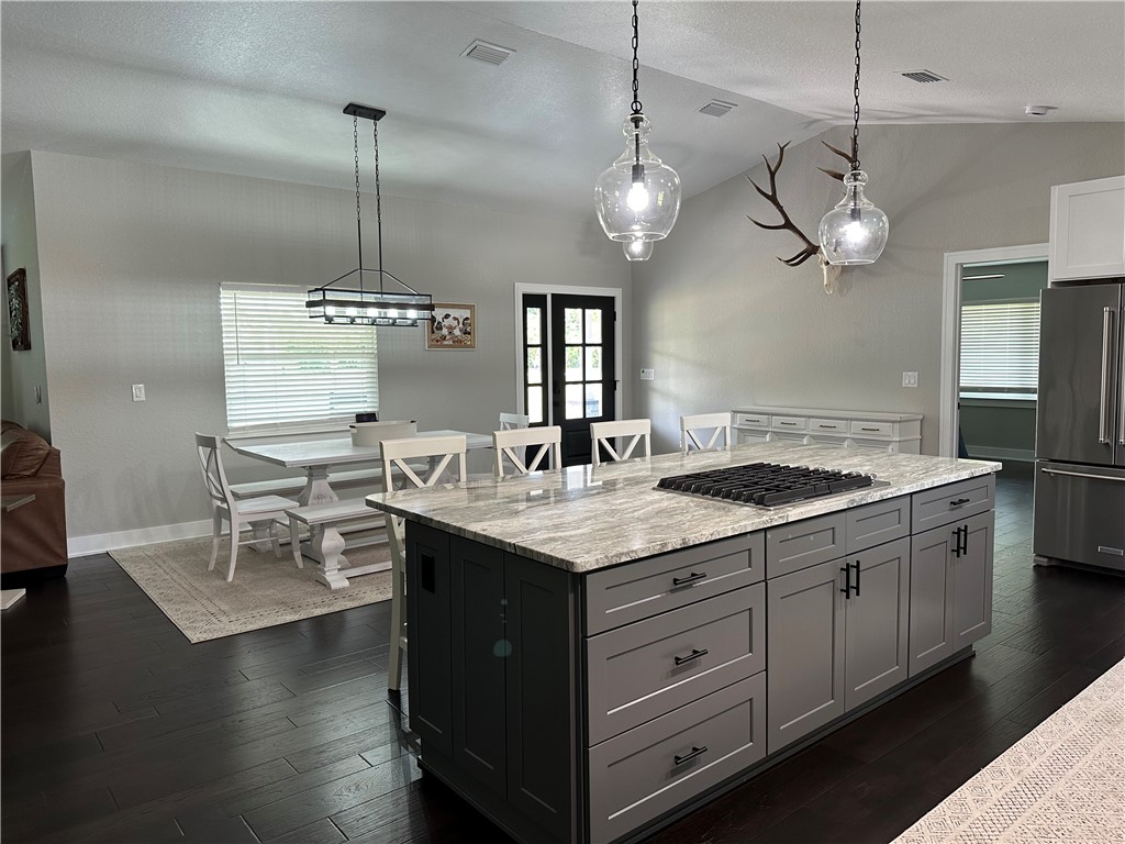 4135 Grant Road Grant Valkaria, FL 32949 - Photo 7 of 26 a kitchen with granite countertop a sink a counter space appliances and cabinets