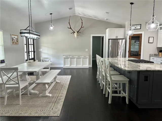 a bedroom with a bed and a lamp on the dresser