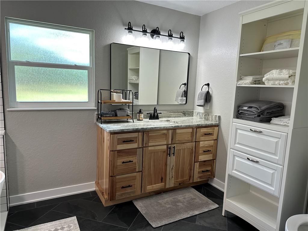 4135 Grant Road Grant Valkaria, FL 32949 - Photo 10 of 26 a bathroom with a double vanity sink and mirror