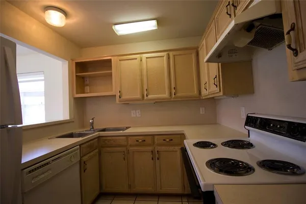 a kitchen with a sink a stove and cabinets