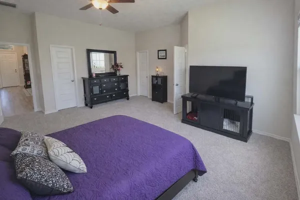 a bedroom with a bed and flat screen tv