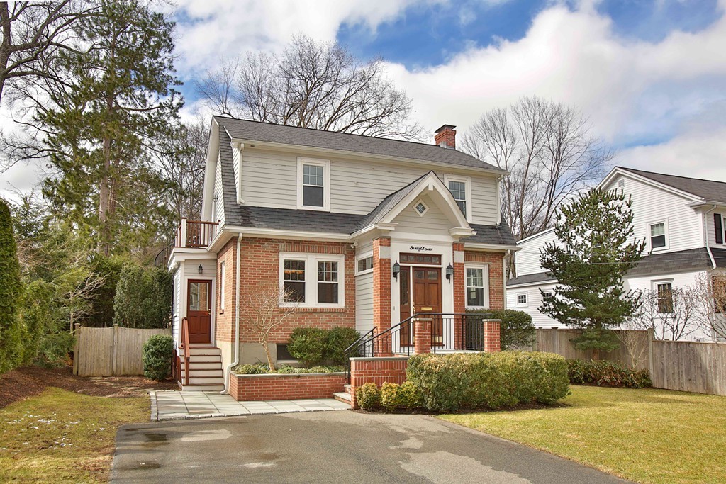 64 Martin Road Wellesley, MA 02481 - Photo 1 of 13 a front view of a house with a garden