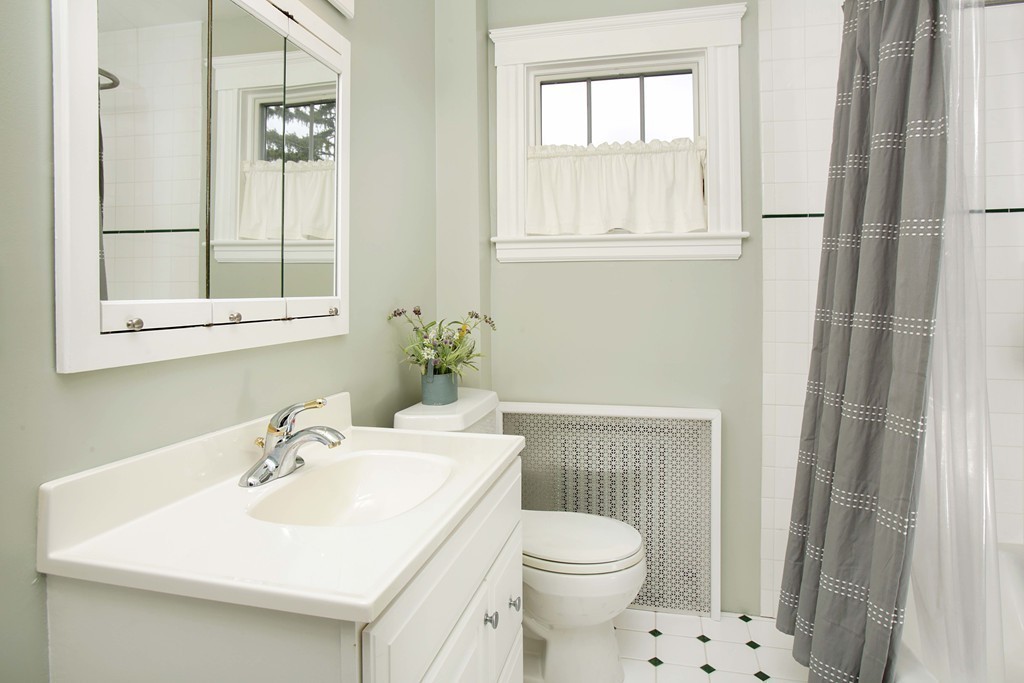 64 Martin Road Wellesley, MA 02481 - Photo 11 of 13 a bathroom with a sink a toilet and a mirror