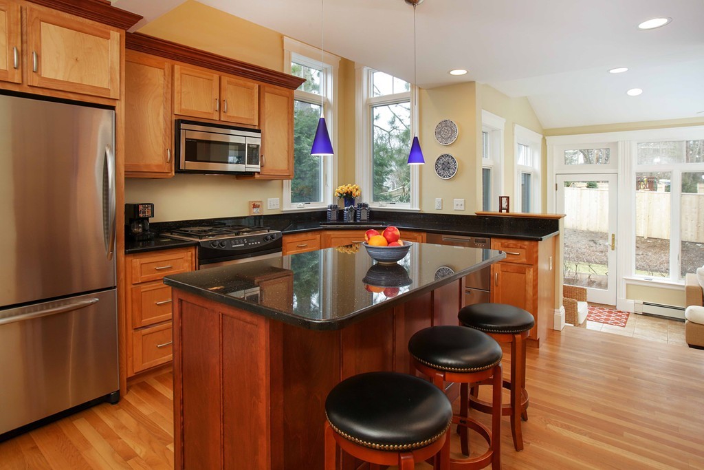 64 Martin Road Wellesley, MA 02481 - Photo 3 of 13 a kitchen with stainless steel appliances a stove a microwave a refrigerator and wooden cabinets