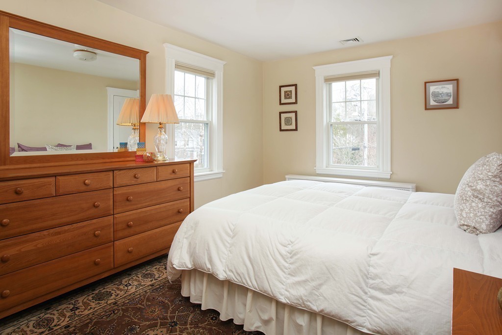 64 Martin Road Wellesley, MA 02481 - Photo 10 of 13 a bedroom with a bed and a dresser next to a window