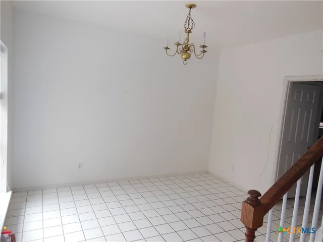 a view of an empty room with stairs