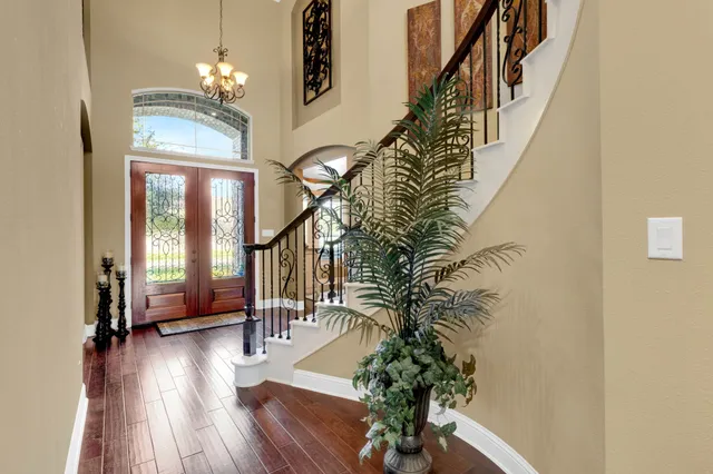 a view of a dining room with furniture and chandelier