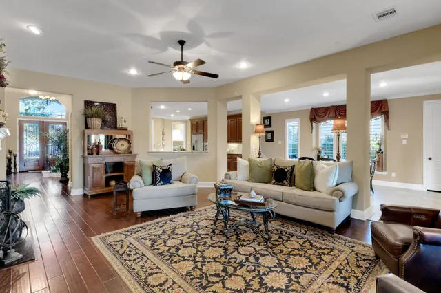 a living room with furniture a fireplace and a flat screen tv