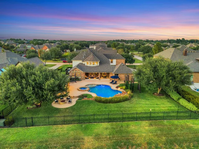 a view of a house with a yard and lake view