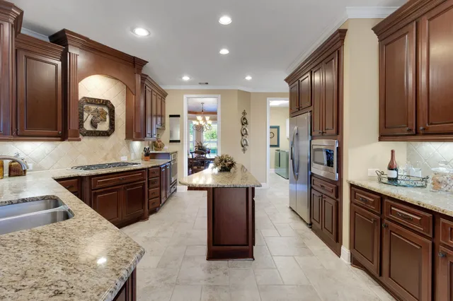 a kitchen with a refrigerator and cabinets