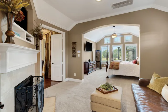 a bedroom with a bed and a flat tv screen on dresser