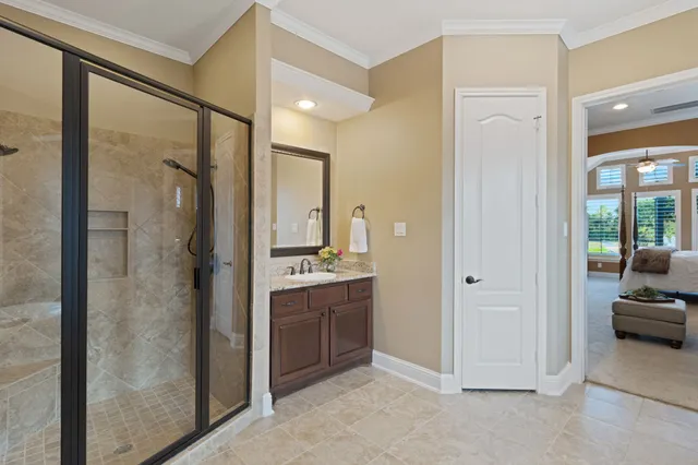 a bathroom with a double vanity sink mirror and shower