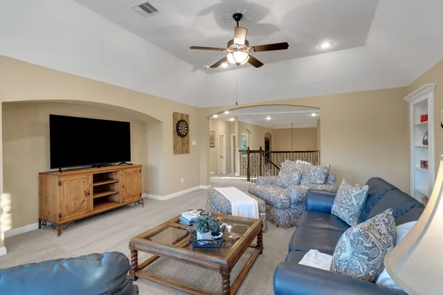 a bedroom with a bed chandelier and a window