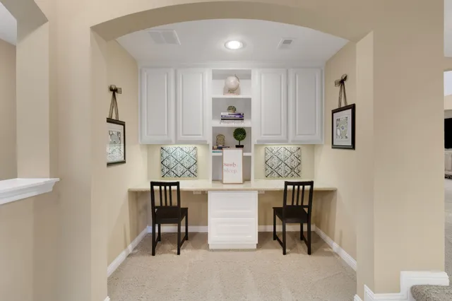 a bedroom with a bed a chandelier and next to a window