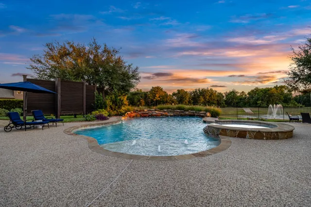 a view of swimming pool with a table and chairs