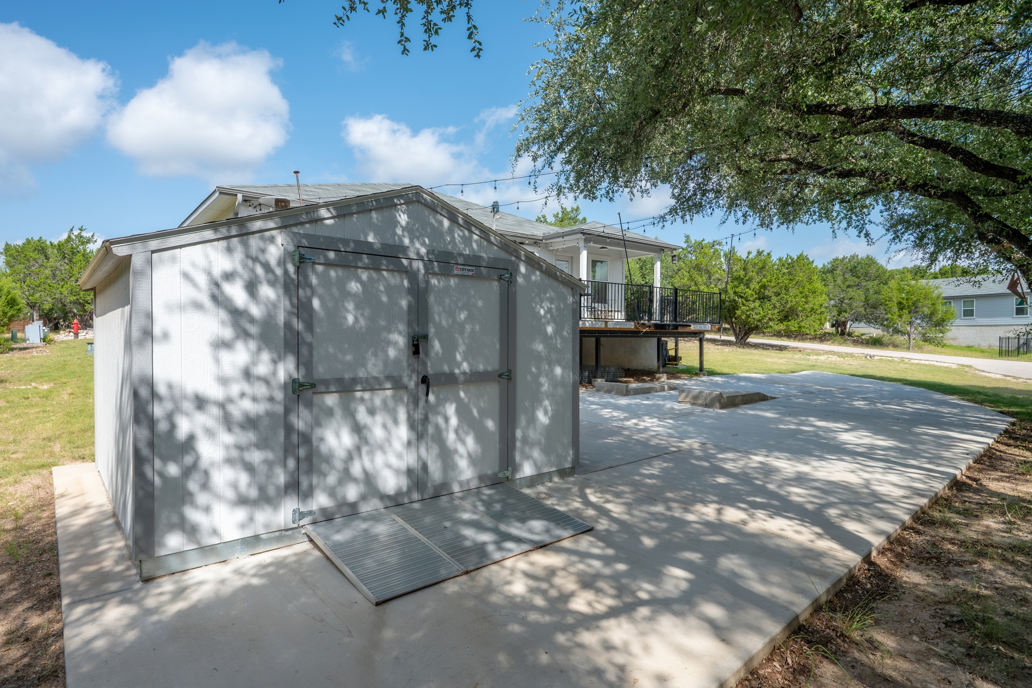 21006 Santa Rosa Avenue Lago Vista, TX 78645 - Photo 21 of 26 A detached storage shed provides ample utility space alongside a concrete patio.