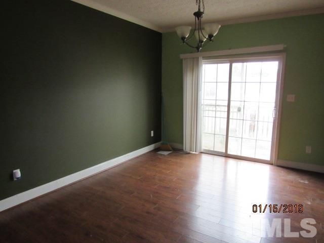 4925 Watkins Road Wendell, NC 27591 - Photo 3 of 10 a view of an empty room with wooden floor and a window