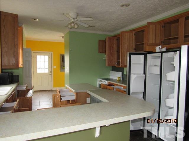 4925 Watkins Road Wendell, NC 27591 - Photo 4 of 10 a kitchen with stainless steel appliances a refrigerator and a sink