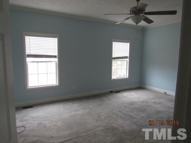 4925 Watkins Road Wendell, NC 27591 - Photo 5 of 10 an empty room with windows and fan