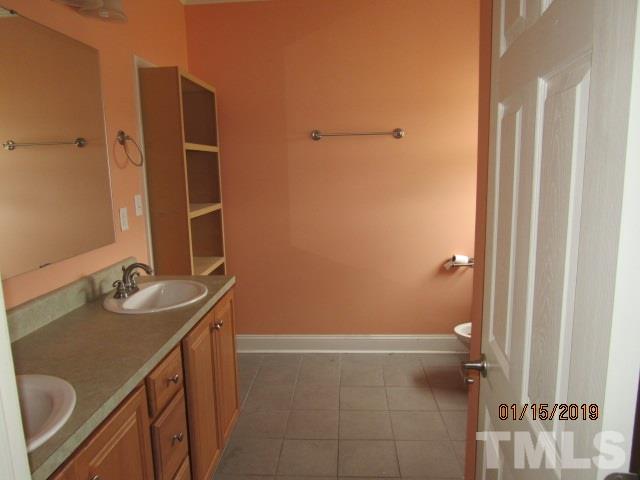 4925 Watkins Road Wendell, NC 27591 - Photo 9 of 10 a bathroom with a sink and mirror