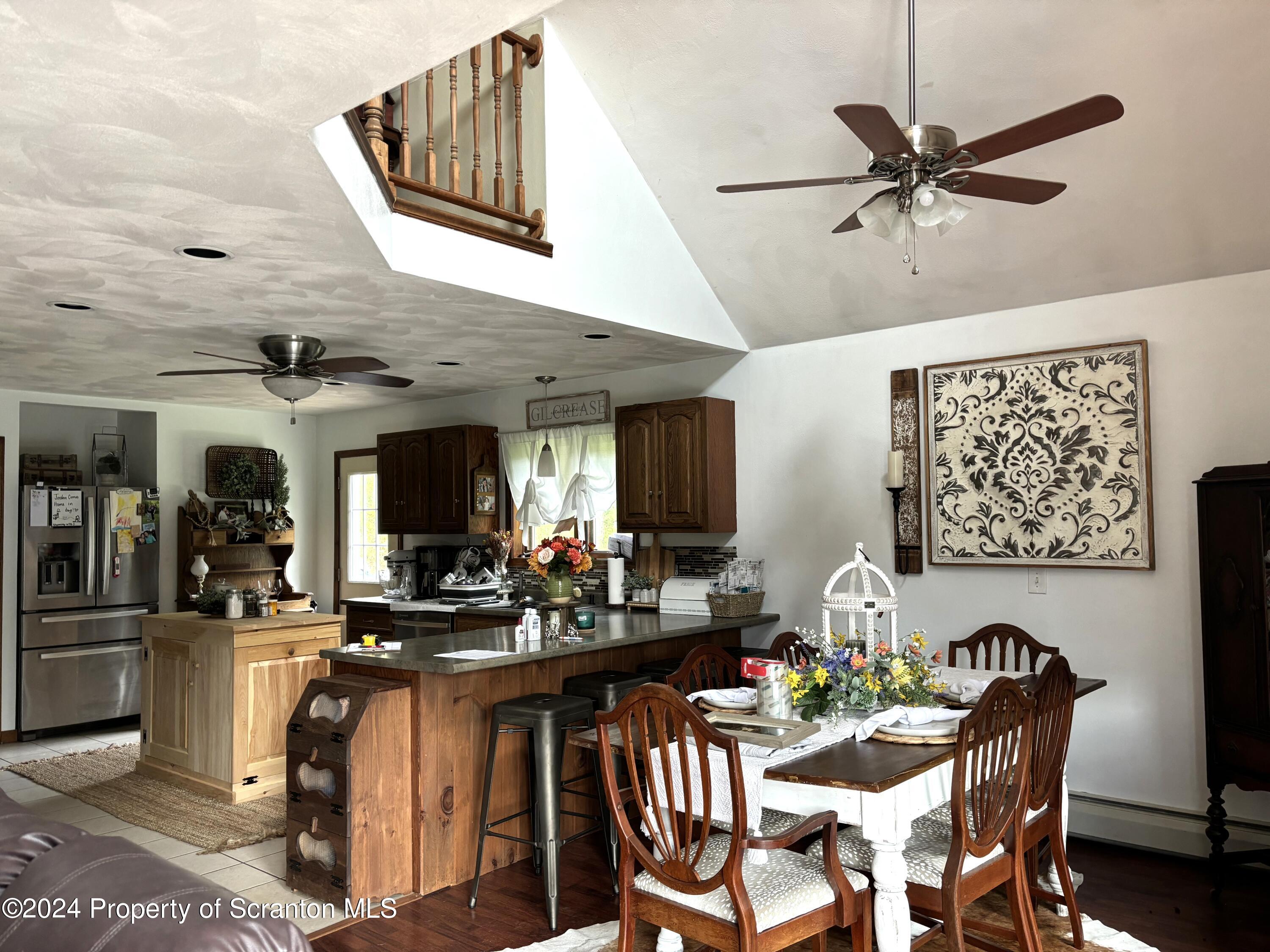 2053 Silver Creek Road Montrose, PA 18801 - Photo 2 of 10 a view of a dining room with furniture and a chandelier