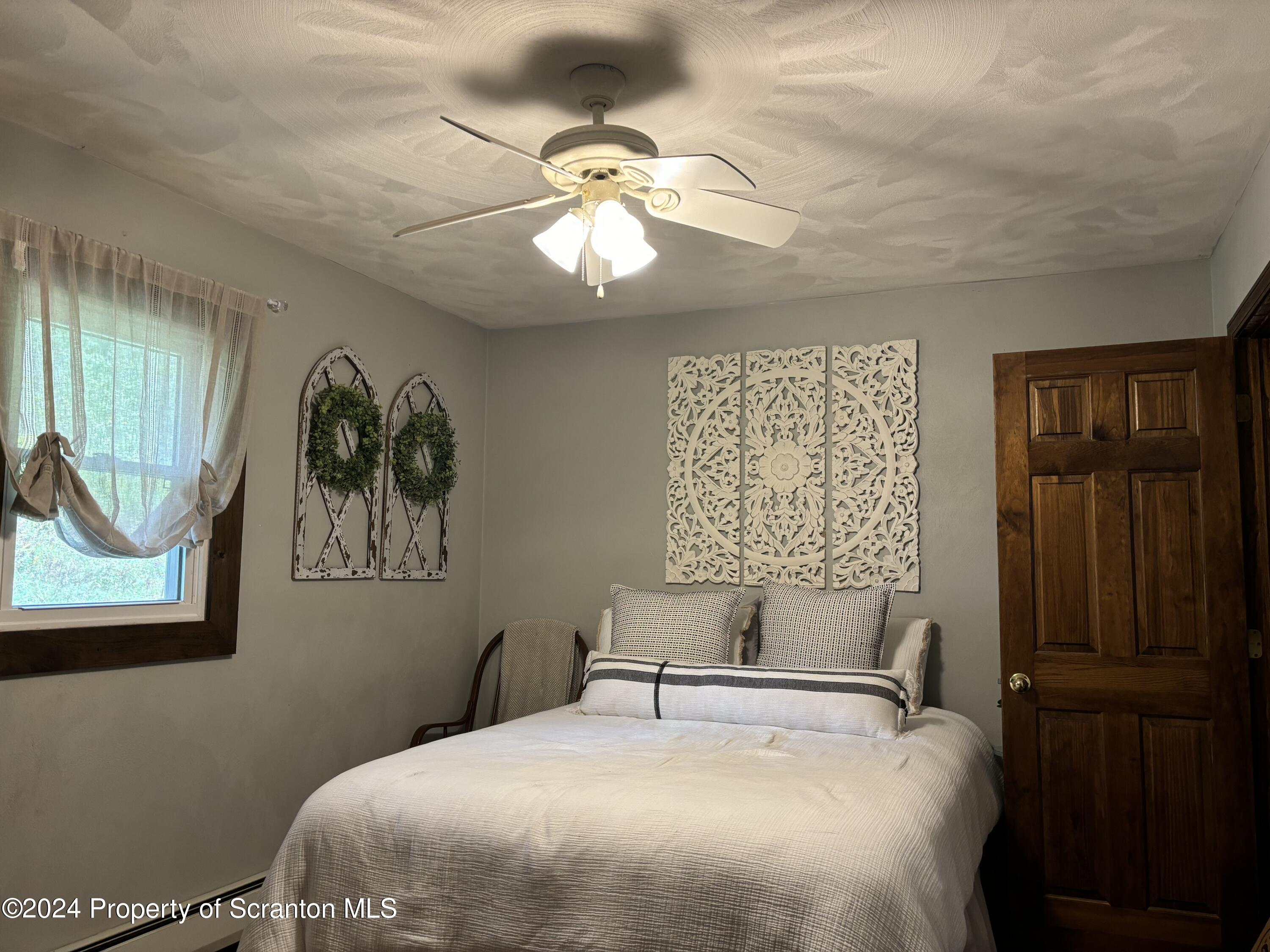 2053 Silver Creek Road Montrose, PA 18801 - Photo 3 of 10 a bedroom with a bed and a window