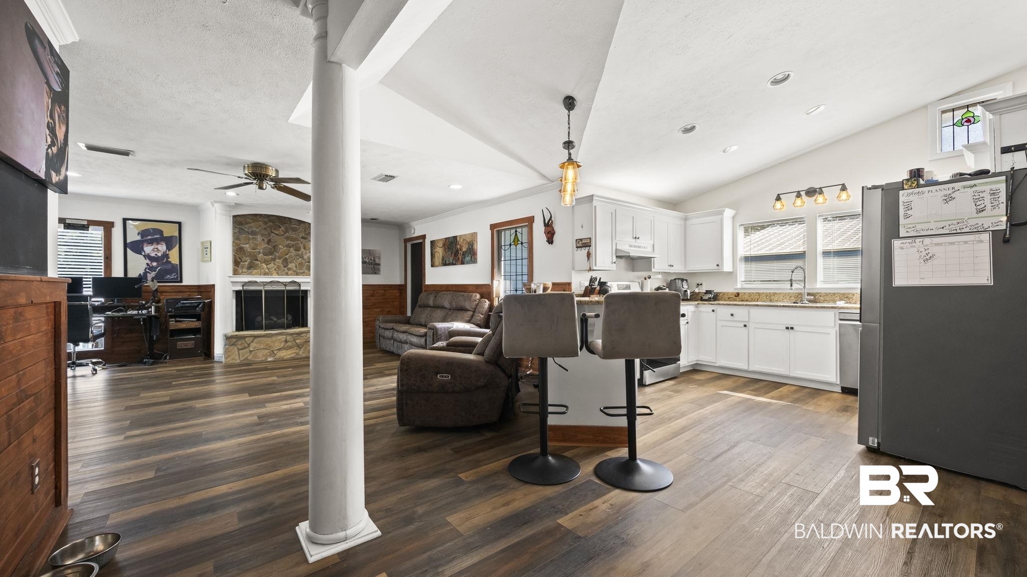 12855 Woodhaven Dairy Road West Silverhill, AL 36576 - Photo 15 of 27 Kitchen with appliances with stainless steel finishes, white cabinetry, a fireplace, dark wood-style flooring, and lofted ceiling
