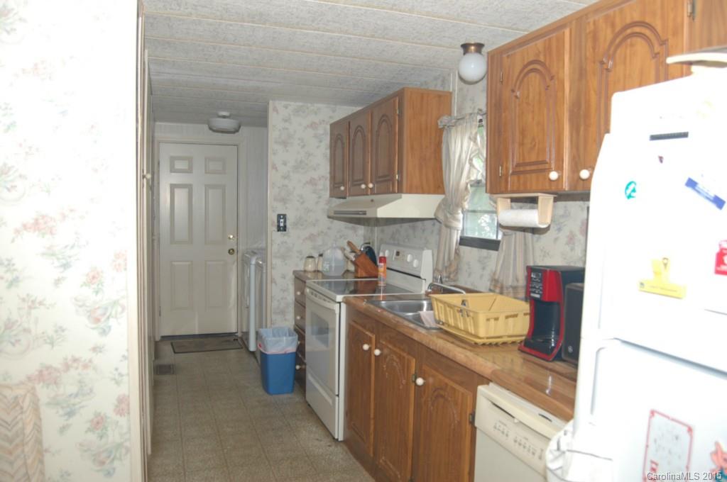 1635 West Ridge Road Salisbury, NC 28147 - Photo 6 of 11 a kitchen with a sink and wooden cabinets