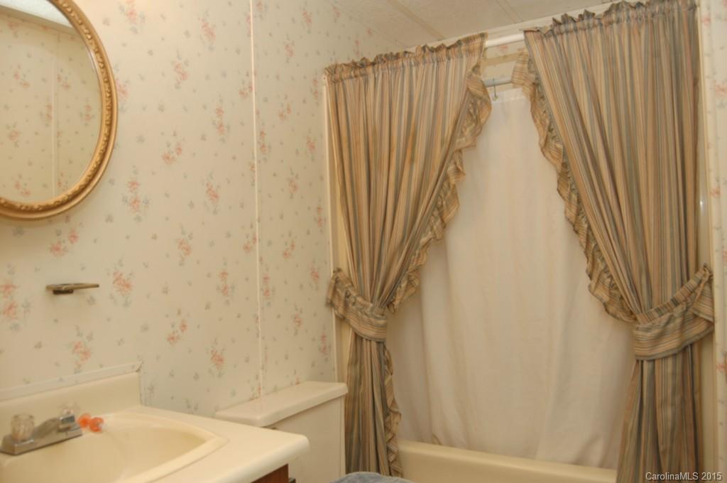 1635 West Ridge Road Salisbury, NC 28147 - Photo 9 of 11 a bathroom with a shower curtain and a sink