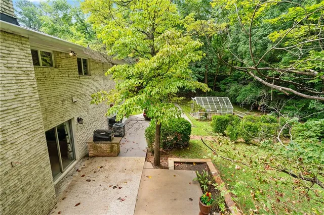 a backyard of a house with chairs