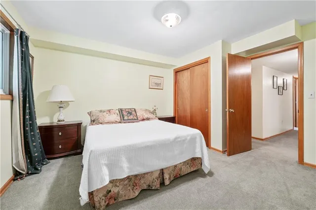 a bedroom with a bed and chair