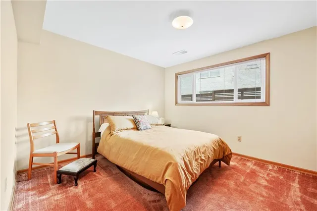 a bedroom with a bed and a desk