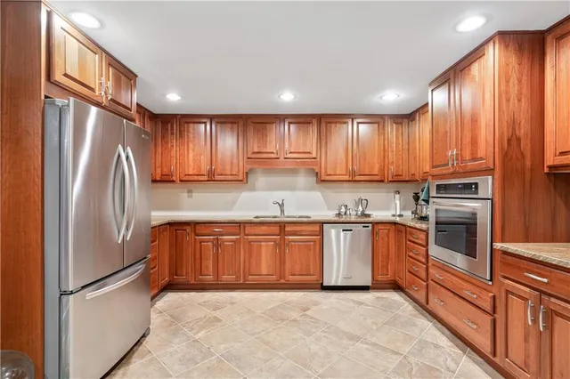 a kitchen with granite countertop a stove a microwave and cabinets