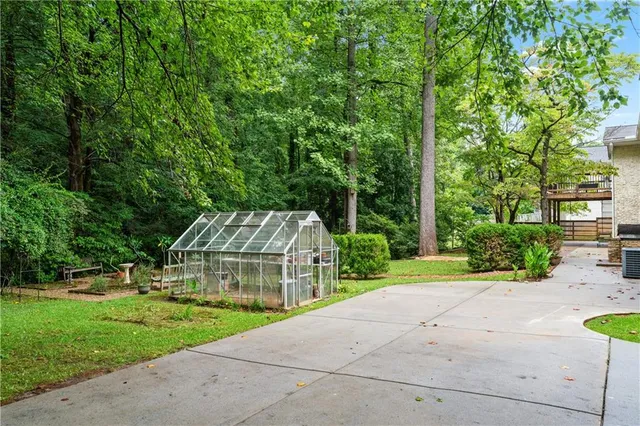 a view of a swimming pool with a patio and a yard