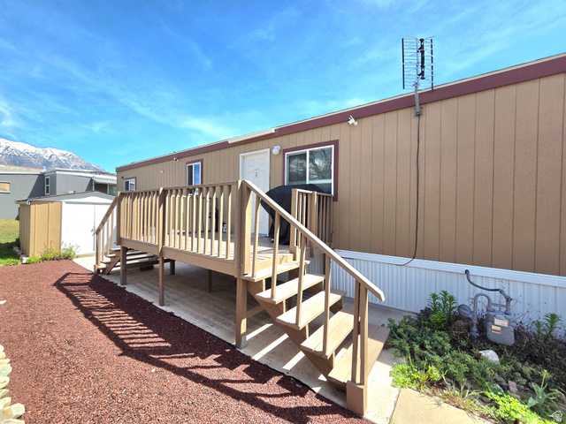 597 North State Street, Unit 67 Orem, UT 84057 - Photo 6 of 23 Back of house with a deck with mountain view and a shed