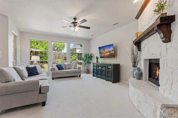 a living room with furniture flat screen tv and a fireplace