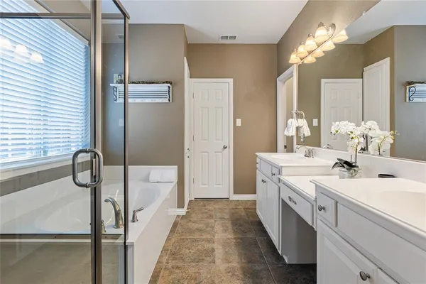 a bathroom with a double vanity sink mirror and shower