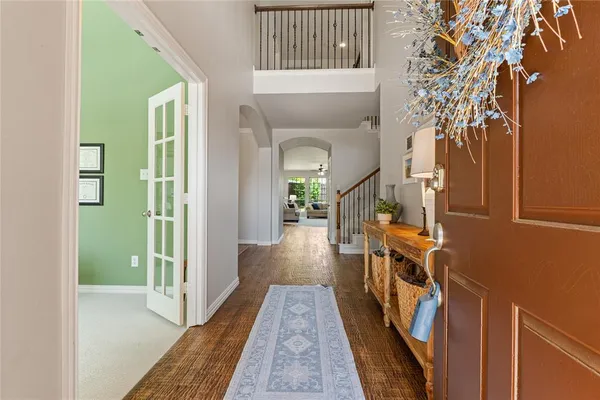 a view of a hallway with wooden floor and staircase