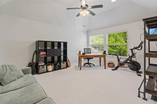 a living room with furniture and a flat screen tv with a large window