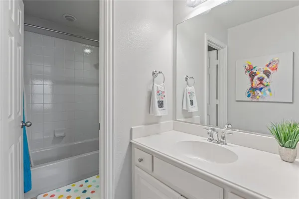 a bathroom with a sink a mirror a bathtub and shower