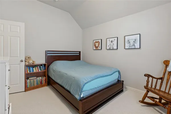 a bedroom with a bed and a chair