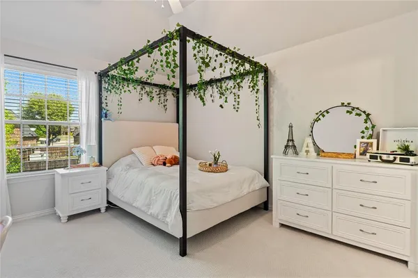 a bedroom with a bed closet and window