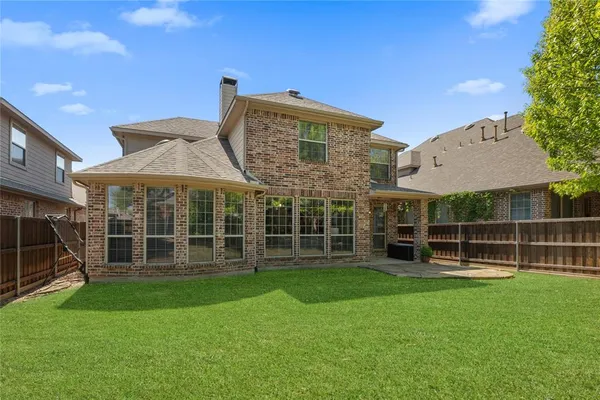 a view of a house with a yard and sitting area