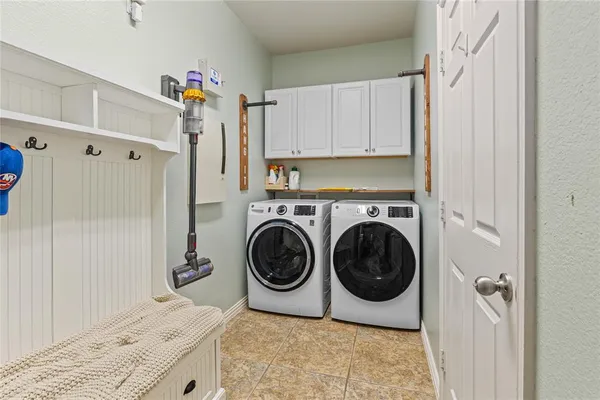 a utility room with sink dryer and washer