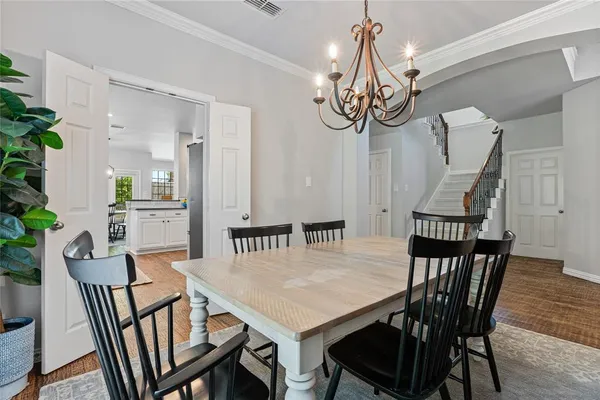 a view of a dining room and hall with furniture