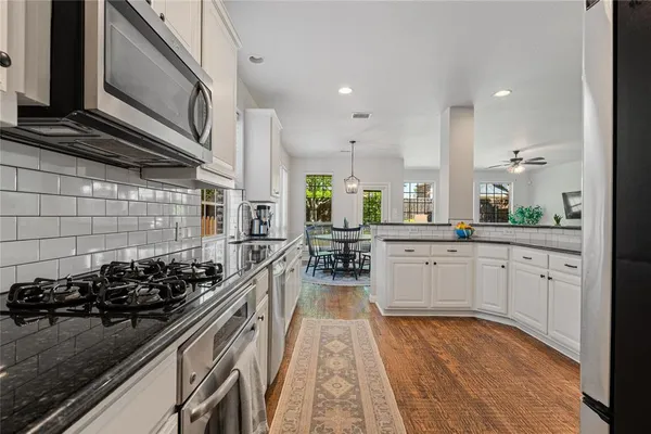 a kitchen with lots of counter top space and stainless steel appliances