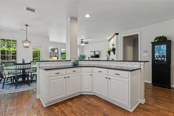 a spacious bathroom with a granite countertop sink and a mirror