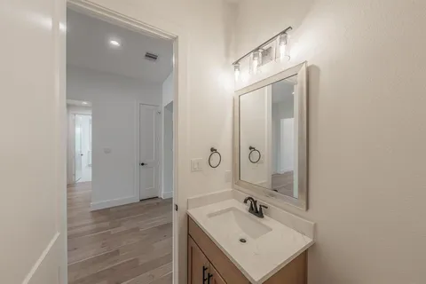 a bathroom with a sink a mirror and a shower